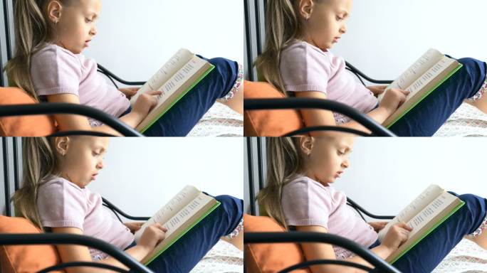 家里的小女生指着课本慢慢地读