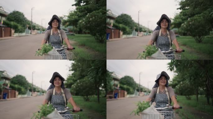 女人骑自行车泰国农村妇女骑自行车买菜回家