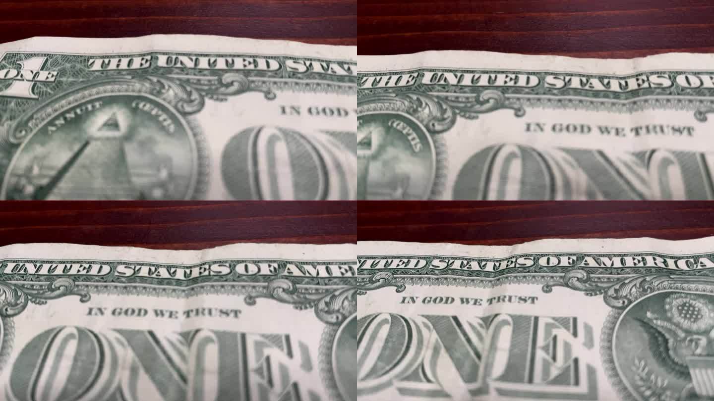 木头桌子上一张美国一美元钞票的滑动镜头