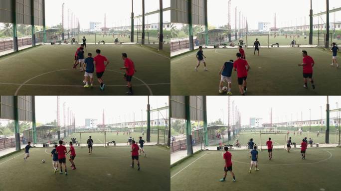 无人机射击：亚洲男子足球运动员与朋友一起打球。