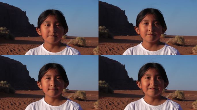 在沙丘和红岩悬崖前纪念碑谷附近的年轻女孩视频肖像从中性表情转变为笑容
