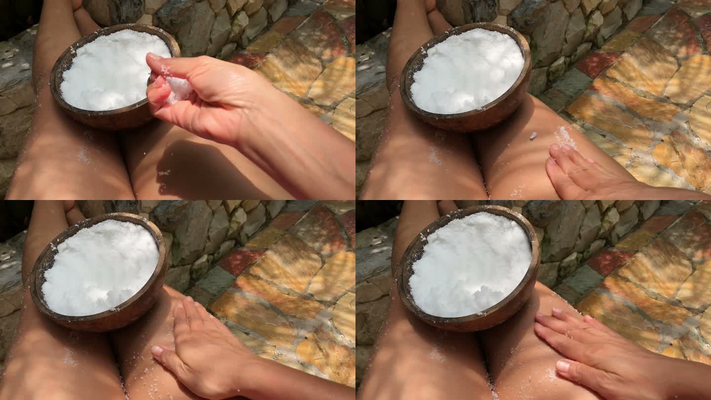 用海盐擦洗皮肤时的女性自拍