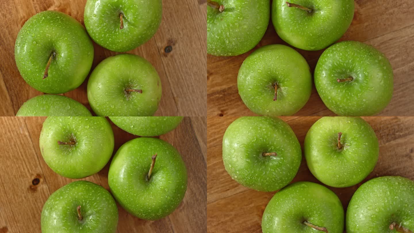绿色的苹果在木桌上旋转