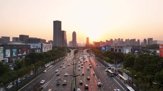 夕阳下高架桥立交桥汽车流交通写字楼航拍