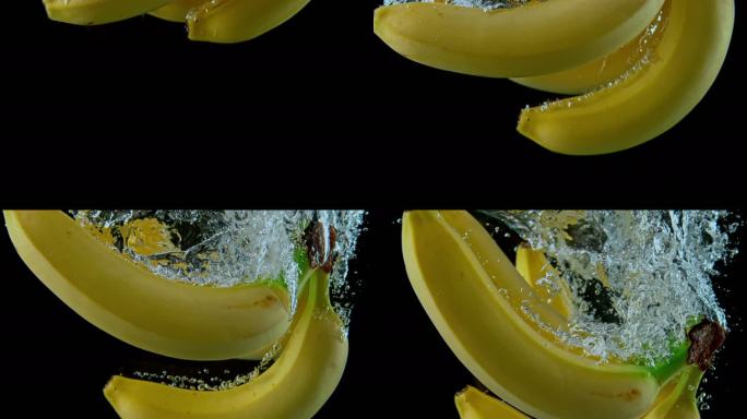 SLO MO LD香蕉落入水中并产生气泡的手
