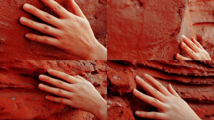 手抚摸红色的岩石 探索自然 感受自然