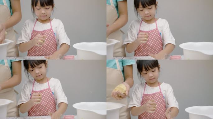 快乐的亚洲孩子学习在家做饼干，女孩一起打糕点面团，生活方式理念。