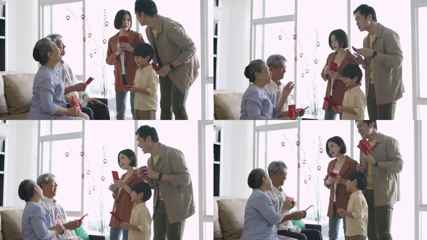 亚洲中国祖父母在家过年时给孙子发红包