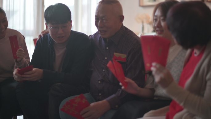 中国新年的孙辈们祝福他们的祖父母收到红包，财源滚滚，好运连连