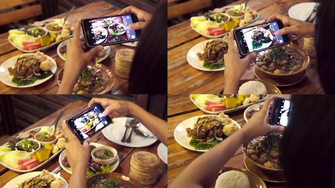 亚洲女性使用手机拍摄泰国食品照片组。