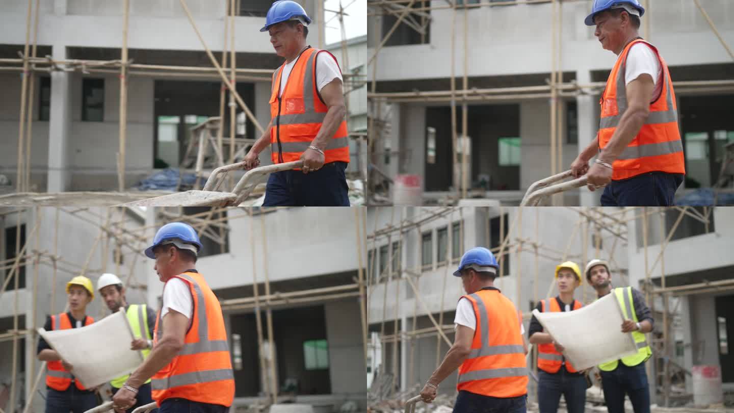 蓝领工人正在建筑工地与同事一起工作。