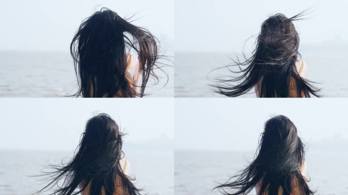 女孩在海边吹风，大风吹起发丝飞舞