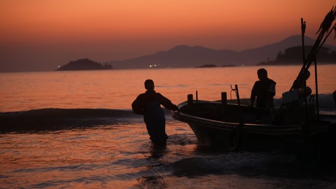 海边夕阳落日渔船渔民剪影