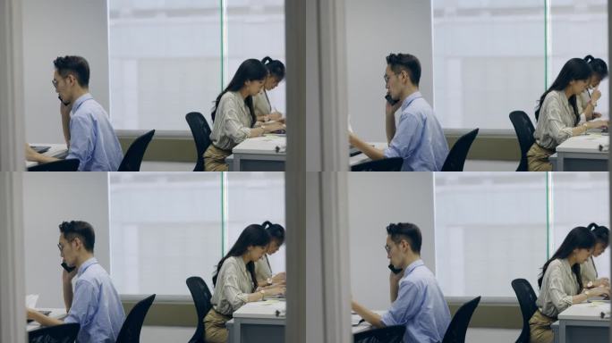亚洲商人在个人办公桌上使用电脑办公。