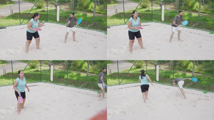 情侣打沙滩网球打球奔跑
