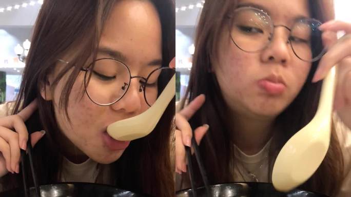 年轻的亚洲女人用筷子吃乌冬，日本面条汤，智能手机的垂直视频