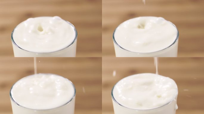 SLO MO牛奶滴落在玻璃杯中