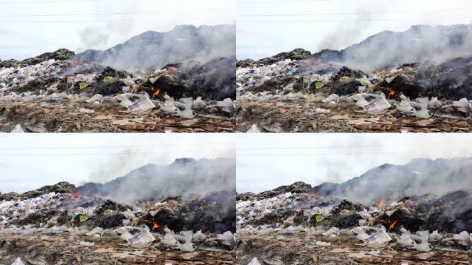 垃圾堆着火了。污染概念。大山垃圾回收场。