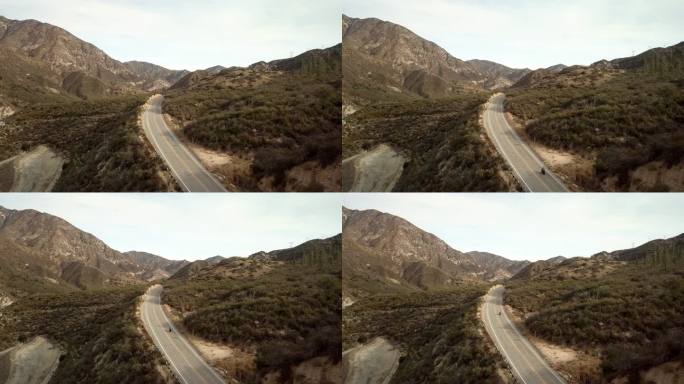 摩托车手在洛杉矶Crest高速公路上驾驶-空中无人机射击