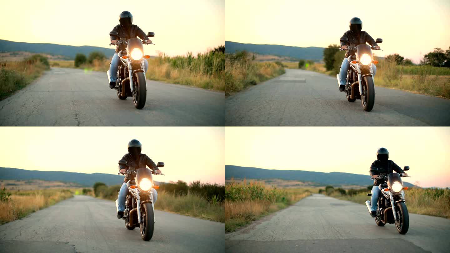 日落时分骑摩托车在空旷的道路上骑行