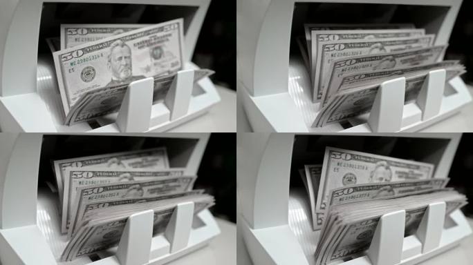 SLO MO LD推动者在货币柜台上将50美元钞票推到堆垛机上