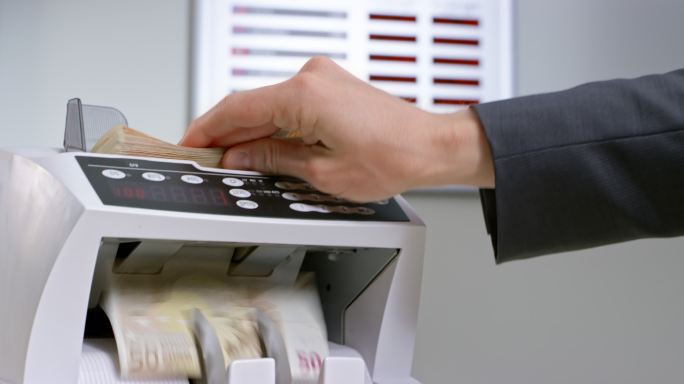 银行员工将50欧元钞票插入自动货币柜台