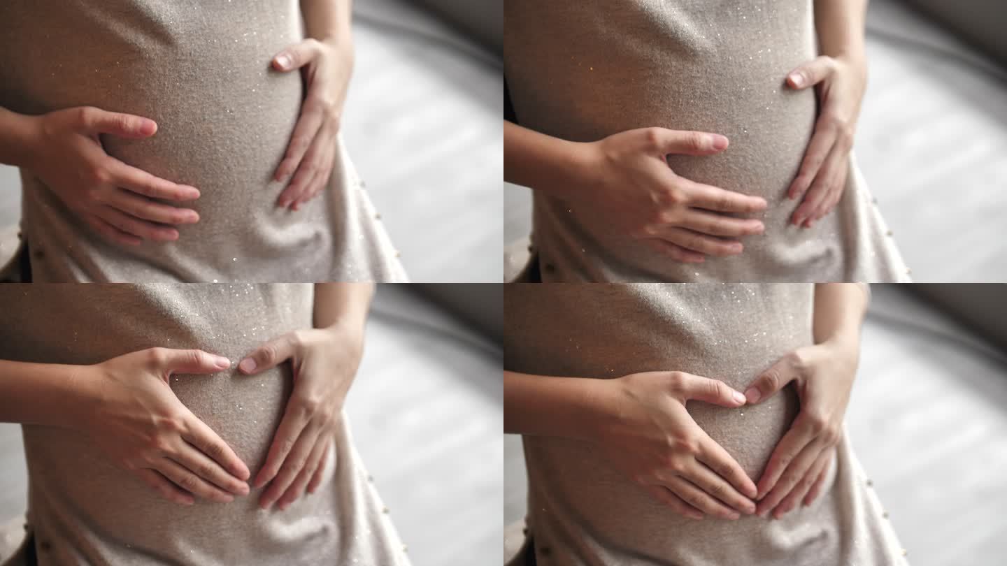 怀孕心手抚摸爱抚特写镜头妊娠期孕期