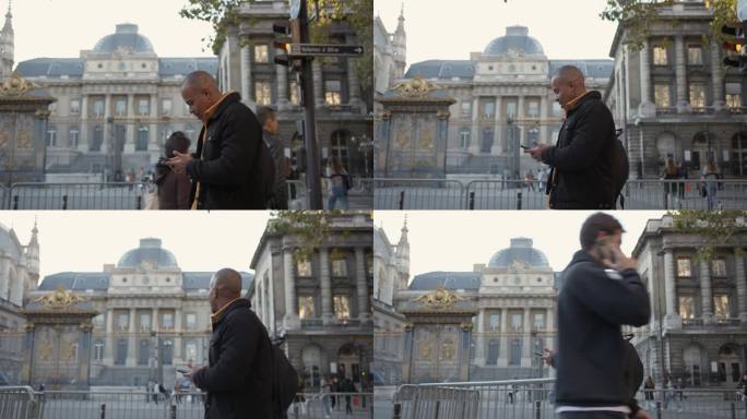 黑人在巴黎漫步并使用智能手机