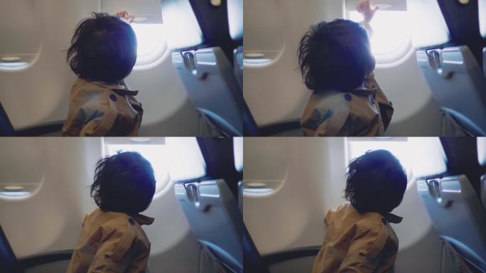 幼儿在飞机上透过窗户观看全景