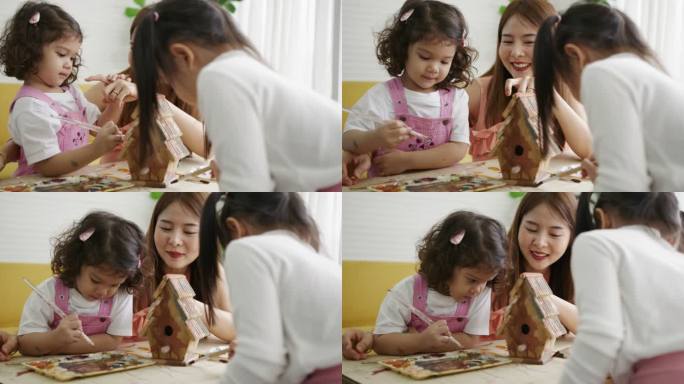 亚洲家庭妈妈教女孩画木屋