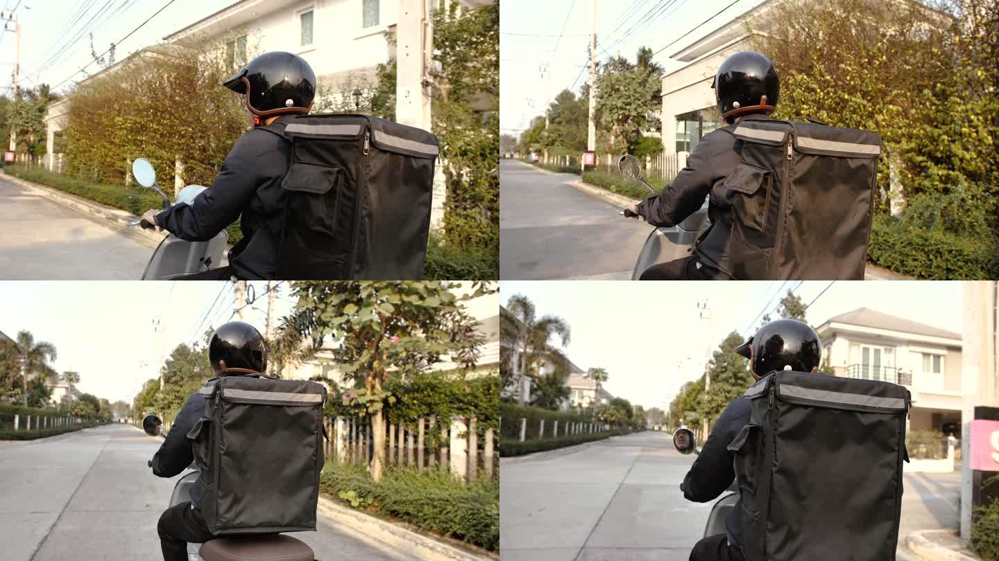 一名年轻的亚洲男子骑着一辆摩托车被要求送到客户家中。