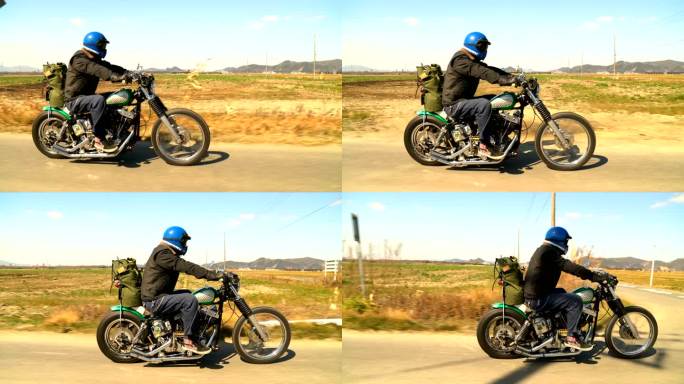 男子骑摩托车在乡村道路上缓慢行驶的侧视图