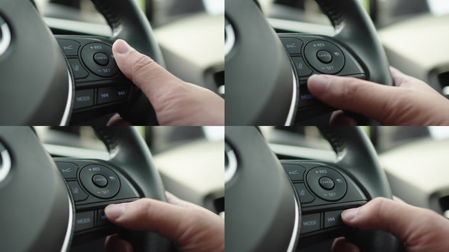驾驶时拇指按下汽车方向盘上的多媒体控制器按钮