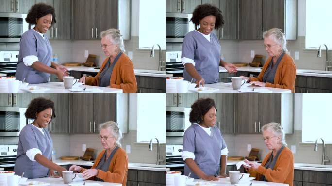 家庭护理员帮助老年妇女在厨房吃饭