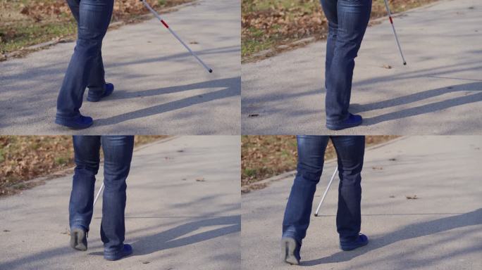 无法辨认的盲人用手杖在公园里行走