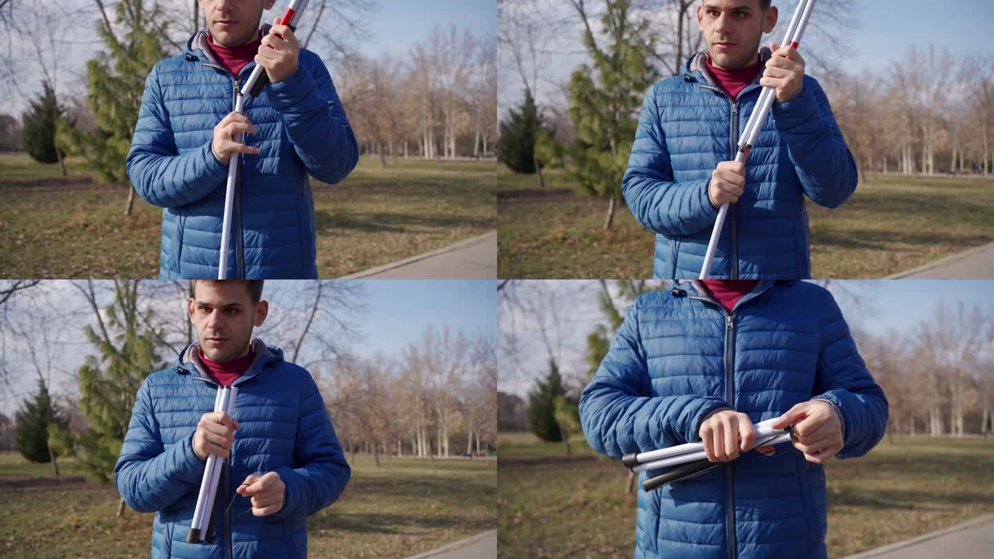 视障男子在公园里收起手杖