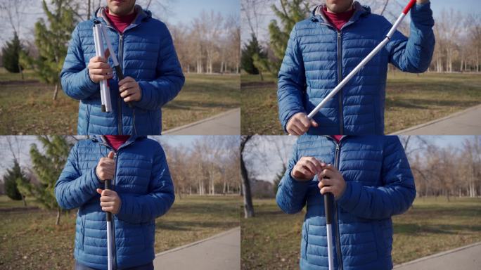 视障男子在公园里打开手杖