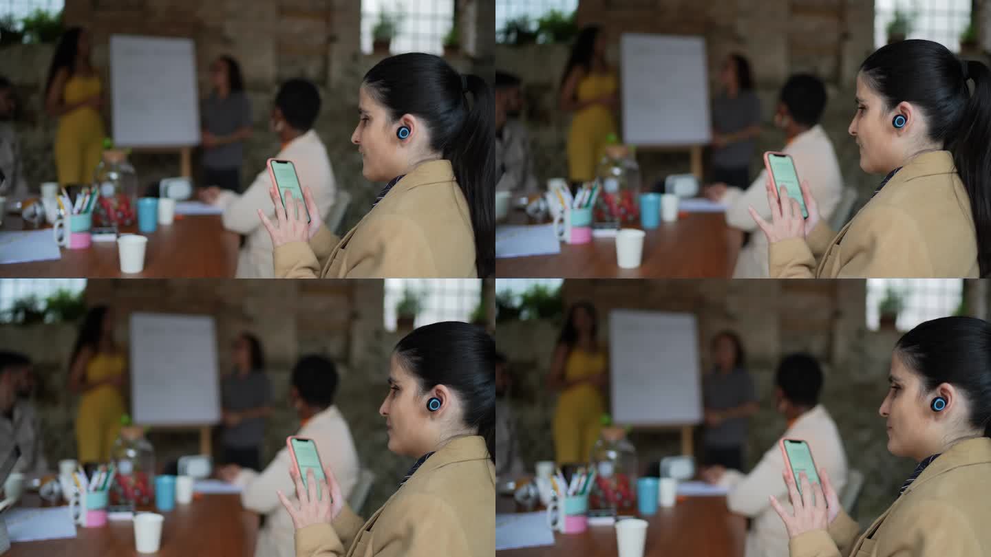 在商务会议上使用智能手机和耳机的视障女商人