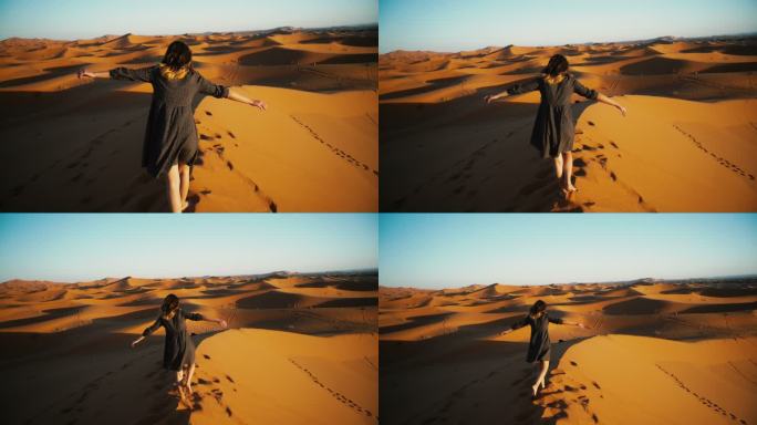日落时分行走在撒哈拉沙漠的女人
