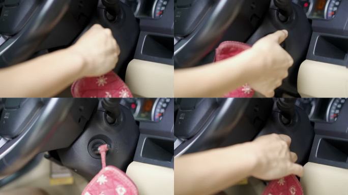 特写女子用钥匙启动汽车引擎的手。
