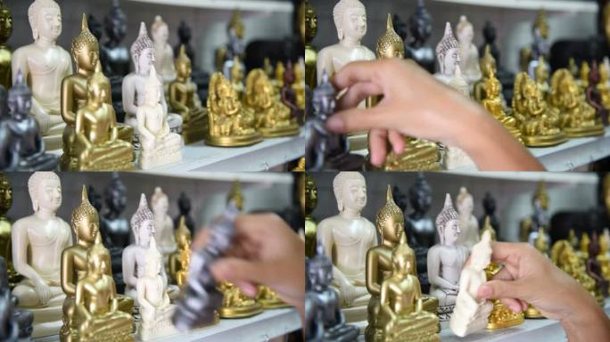 泰国一名女游客在纪念品商店挑选佛像。