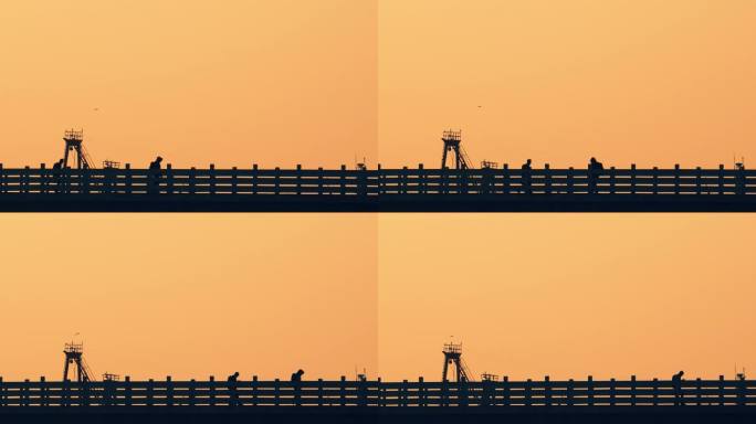 剪影夕阳日落桥边栏杆栅栏路人行走路过建筑