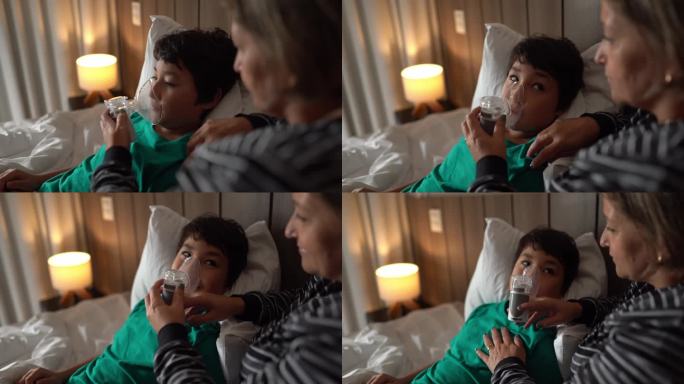 母亲在家中的床上帮助儿子使用喷雾器进行吸入治疗