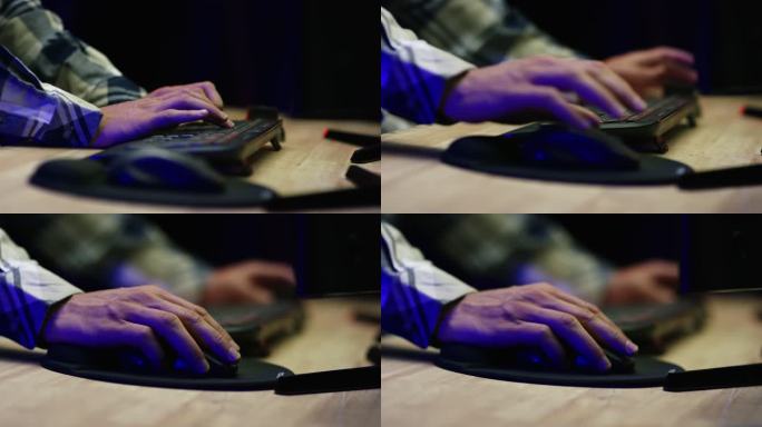 一个白人的手在电脑鼠标上点击并在电脑键盘上打字