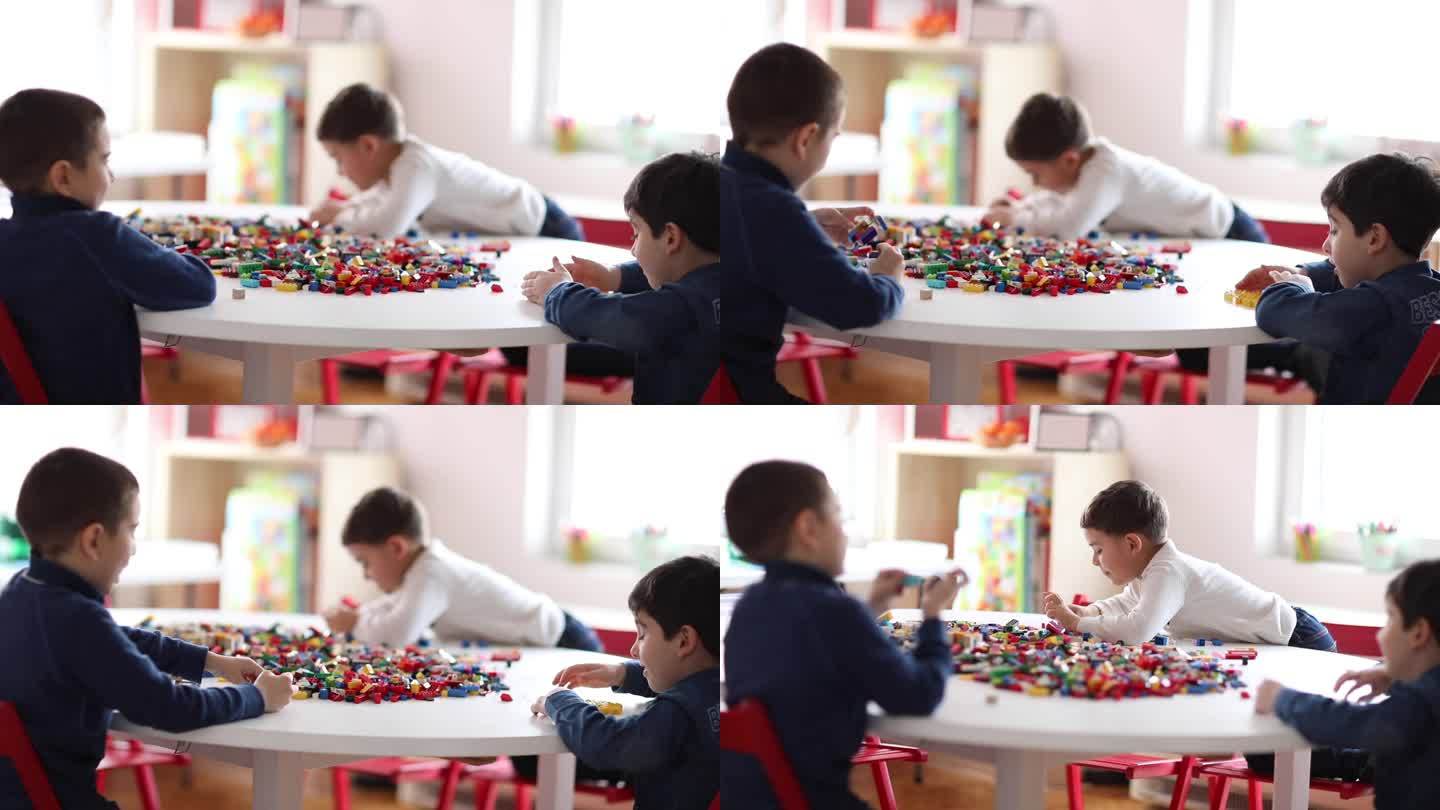 学龄前男孩在私立学校的游戏室玩塑料积木