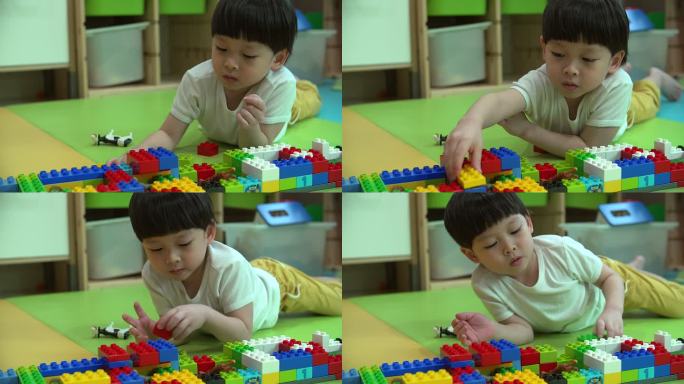 小男孩玩彩色塑料砖的特写镜头。