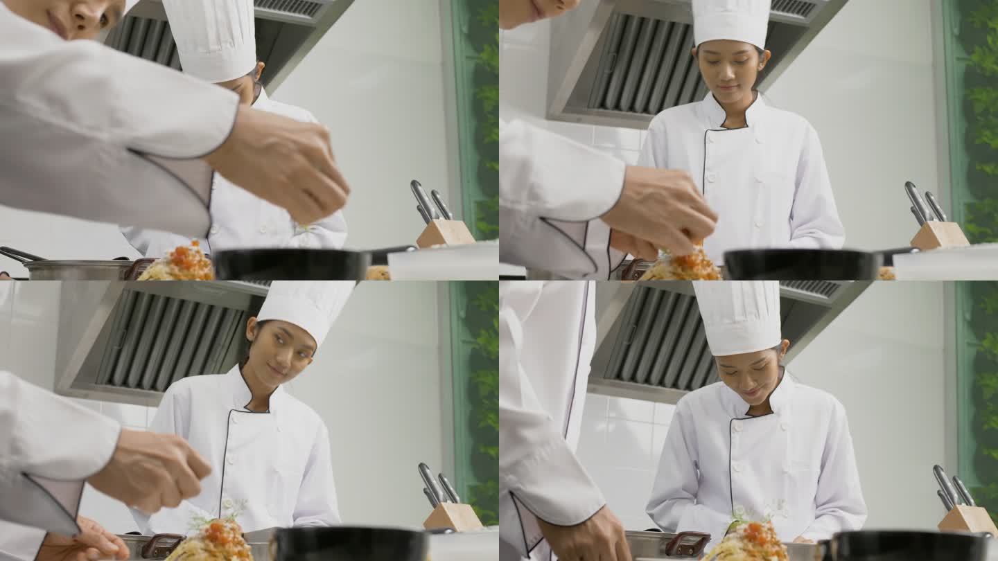 专业的亚洲厨师在商业厨房准备饭菜。