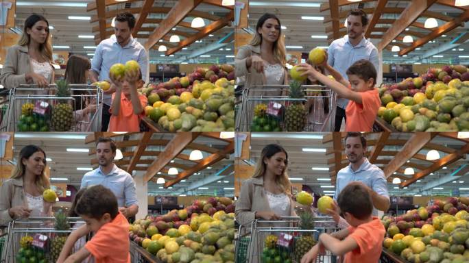 快乐的拉丁美洲家庭在超市购买食品杂货，孩子们在挑选水果，并将其加入购物车