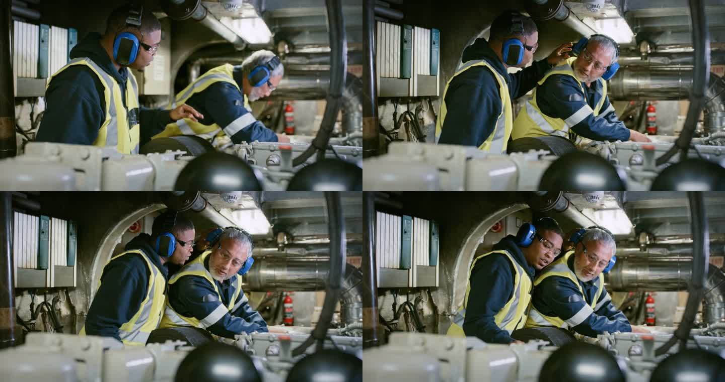 两名维修技师在技术室修理机器发动机时戴着降噪耳机。技术人员和工程师一起维修和解决机械问题