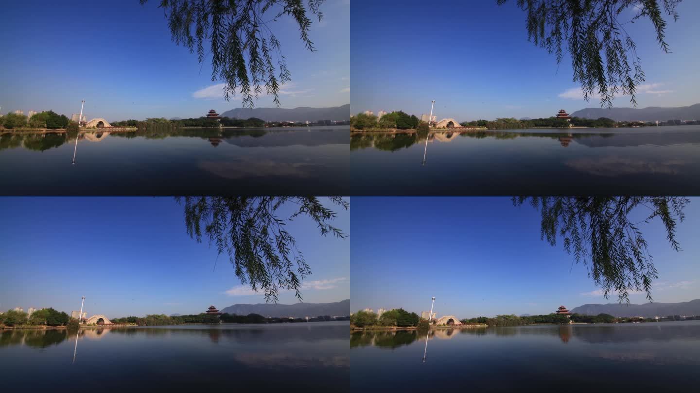 西湖公园湖面桥柳树柳叶蓝天白云
